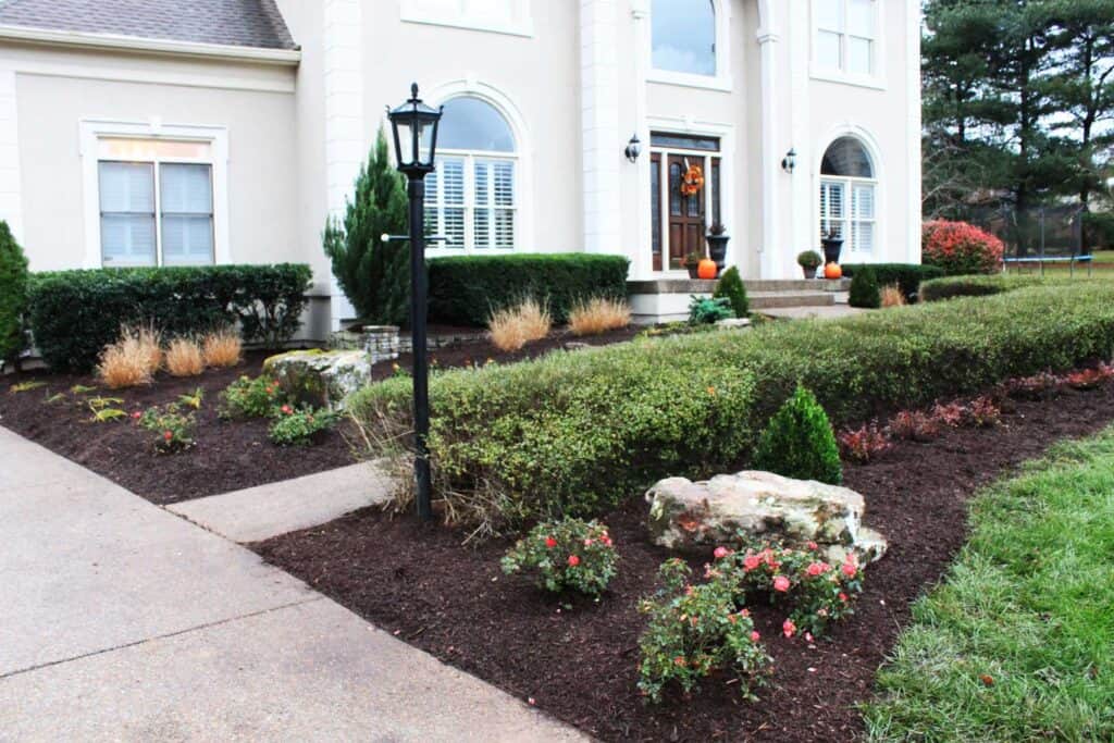 Landscaping with a Boulders and Boxwoods and roses Franklin