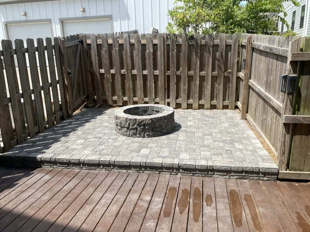 Gray three piece paver patio with gray firepit Forest Hills